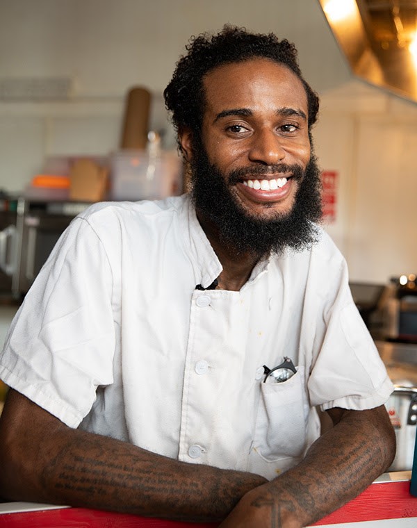 A headshot image of Tarell Mcintosh - a care-experienced restaurant owner